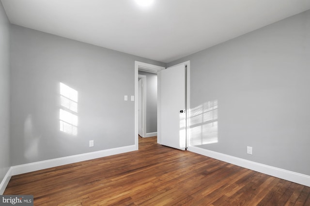 unfurnished room featuring dark hardwood / wood-style flooring