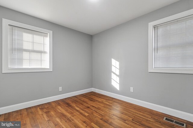 empty room with hardwood / wood-style floors