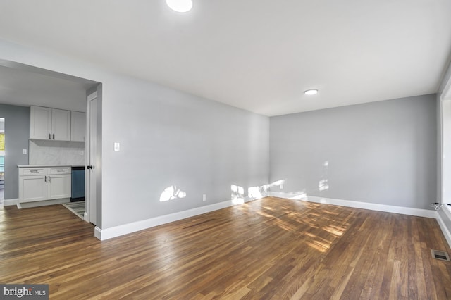 spare room featuring dark hardwood / wood-style flooring