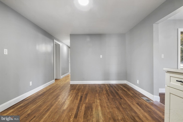 spare room featuring dark hardwood / wood-style flooring