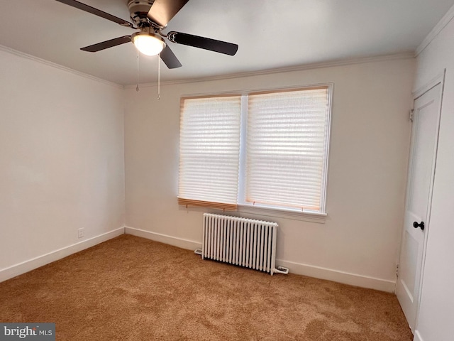 carpeted spare room featuring radiator heating unit, ceiling fan, and ornamental molding