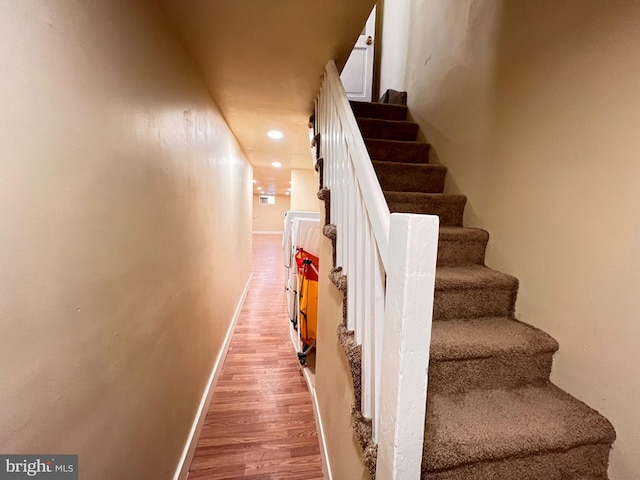 stairs featuring wood-type flooring