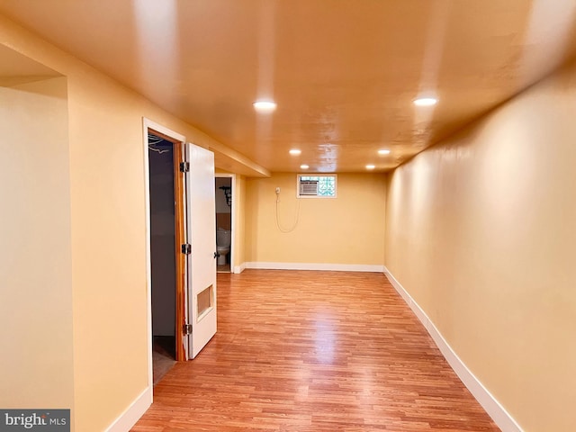 basement with hardwood / wood-style flooring