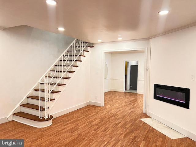 interior space featuring hardwood / wood-style floors and ornamental molding