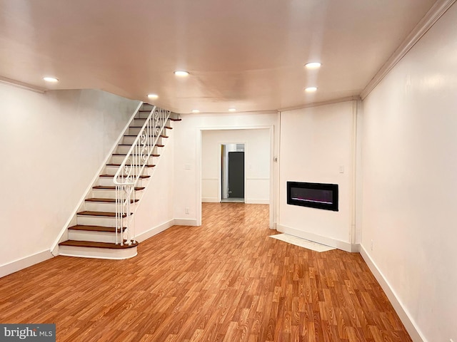 basement with crown molding and light wood-type flooring