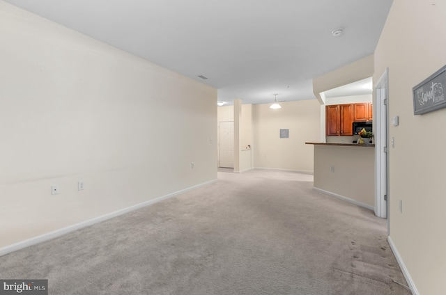 unfurnished living room featuring light carpet