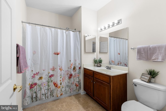 bathroom featuring toilet, walk in shower, vanity, and tile patterned flooring