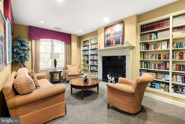 living area featuring carpet and built in shelves