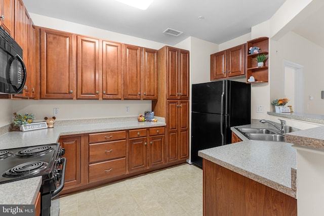 kitchen with black appliances, sink, and kitchen peninsula