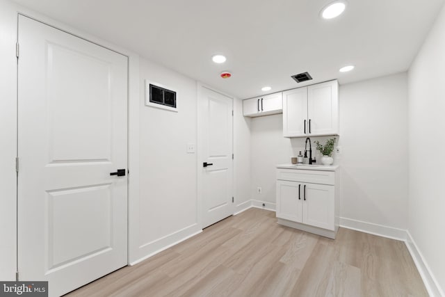 washroom featuring sink and light wood-type flooring