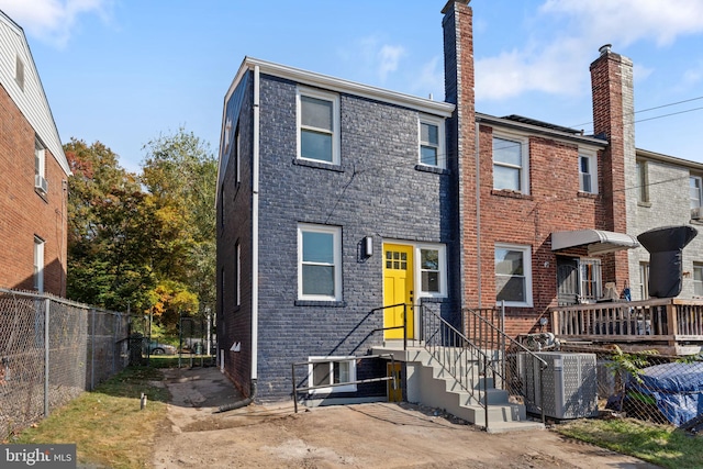 back of house featuring cooling unit