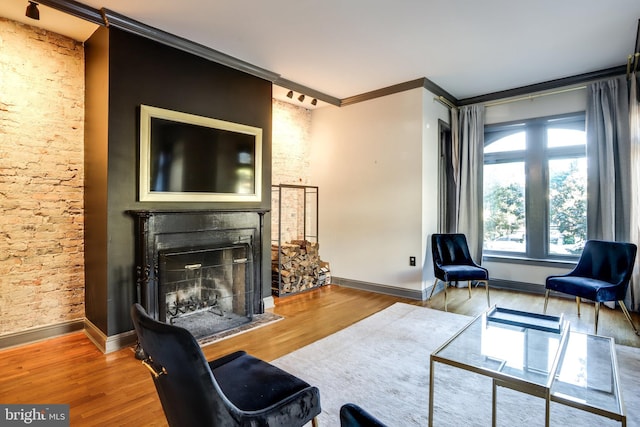 living room with ornamental molding and wood-type flooring