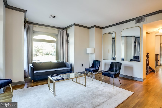 living room featuring crown molding and wood-type flooring