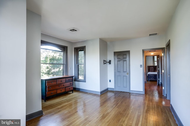 unfurnished bedroom with hardwood / wood-style flooring