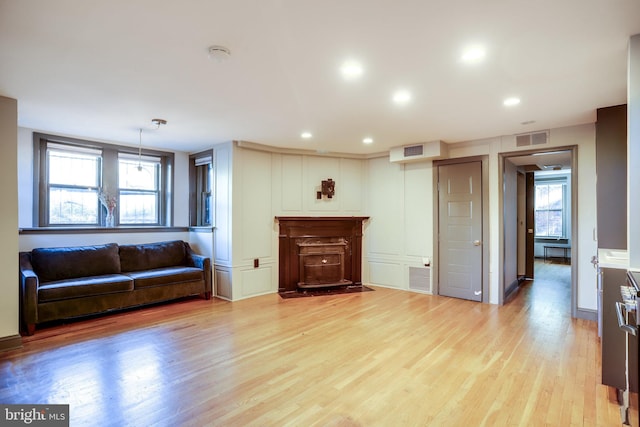 living room featuring light hardwood / wood-style floors and a wealth of natural light