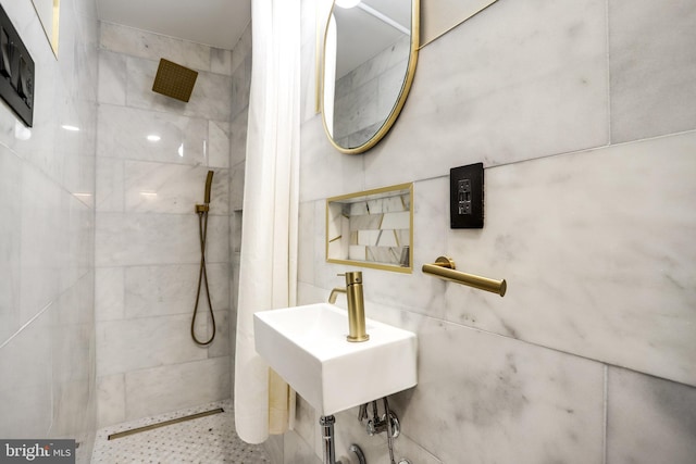 bathroom with sink and tiled shower