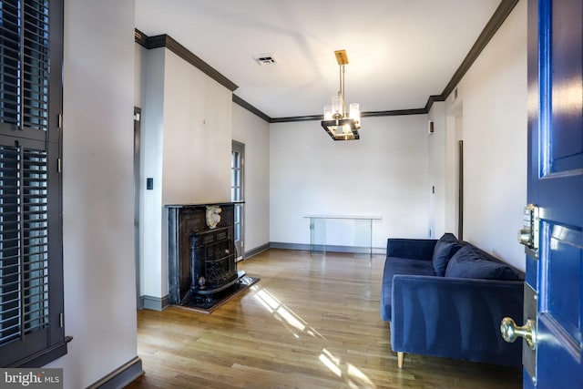 living room featuring hardwood / wood-style flooring and ornamental molding