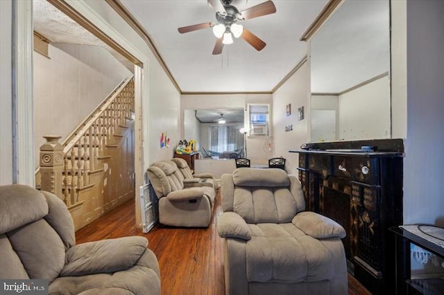 living room featuring ornamental molding, hardwood / wood-style floors, and ceiling fan