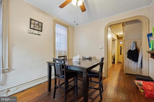 dining space featuring dark wood-type flooring and ceiling fan