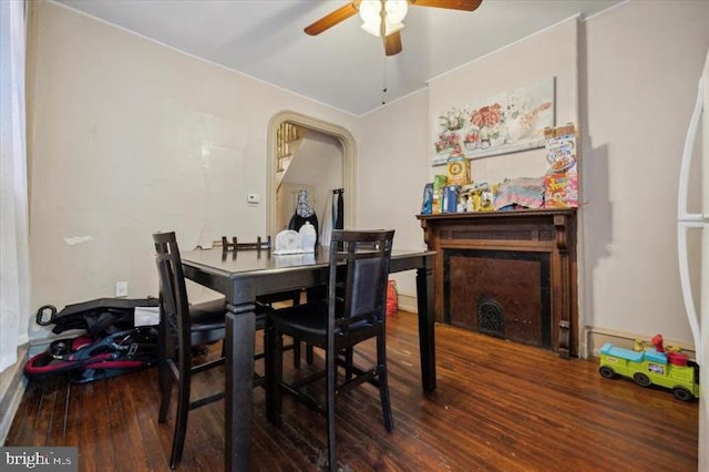 dining room with ceiling fan and dark hardwood / wood-style flooring