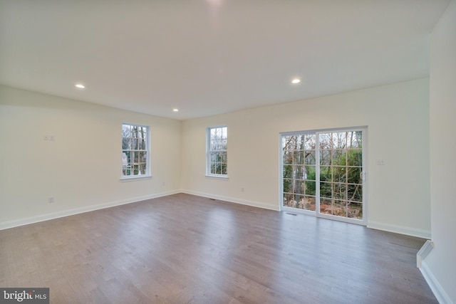 unfurnished room with hardwood / wood-style flooring