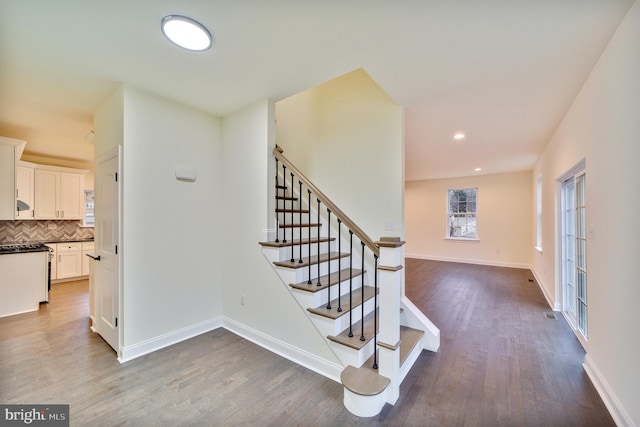 stairway with hardwood / wood-style flooring