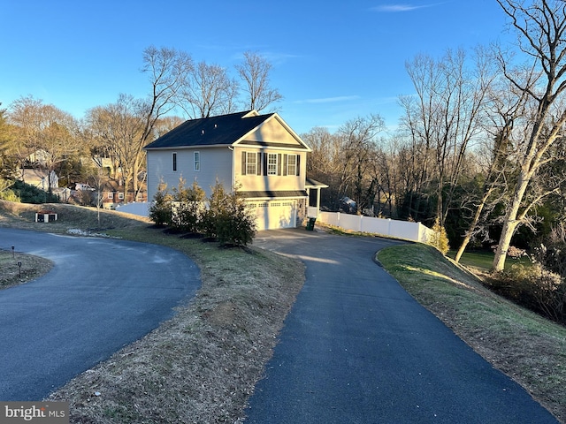 view of side of property with a garage