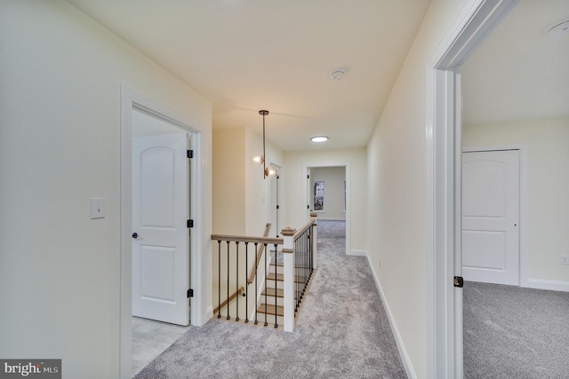 hallway featuring light colored carpet