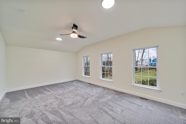 carpeted empty room featuring ceiling fan and lofted ceiling