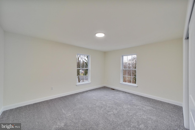 unfurnished room with carpet floors