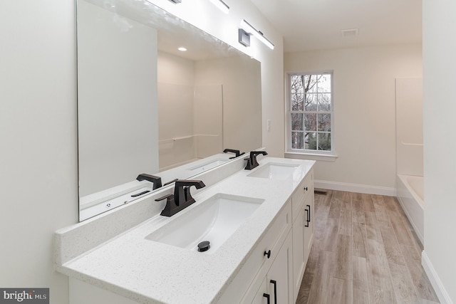 bathroom featuring vanity, shower with separate bathtub, and wood-type flooring