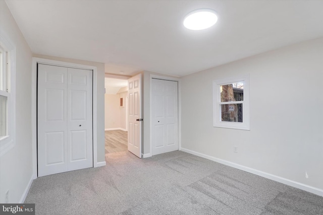 unfurnished bedroom featuring light colored carpet