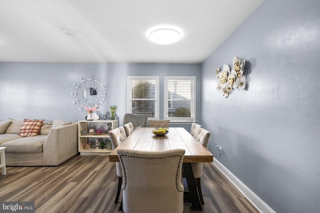 dining space featuring dark wood-type flooring