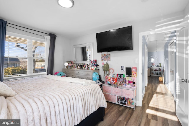 bedroom with dark hardwood / wood-style flooring