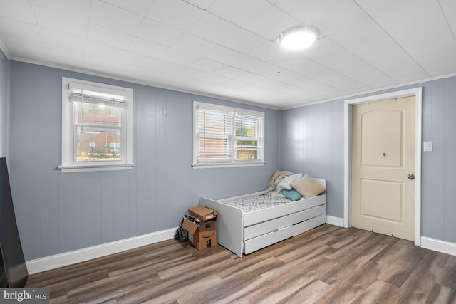 bedroom featuring dark hardwood / wood-style flooring and ornamental molding