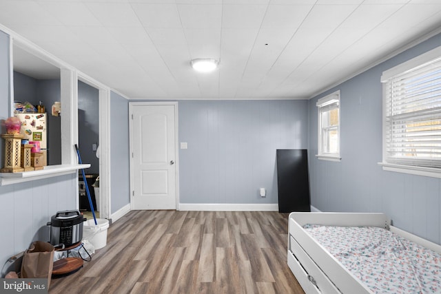 bedroom featuring stainless steel refrigerator and light hardwood / wood-style floors