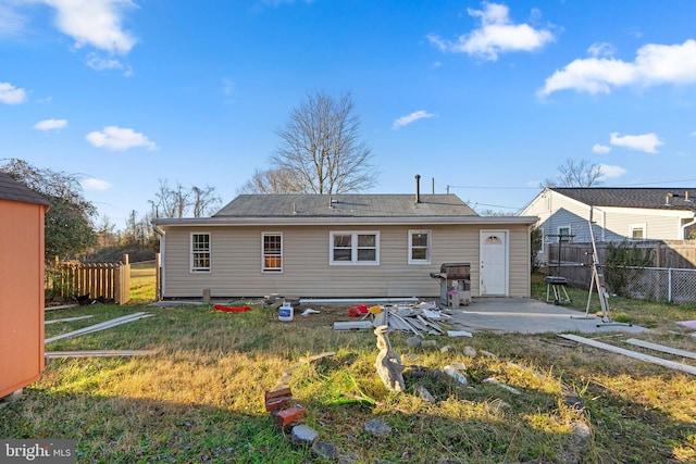 rear view of property with a yard and a patio