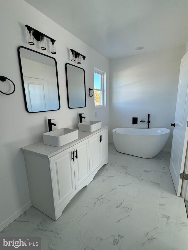 bathroom featuring vanity and a tub