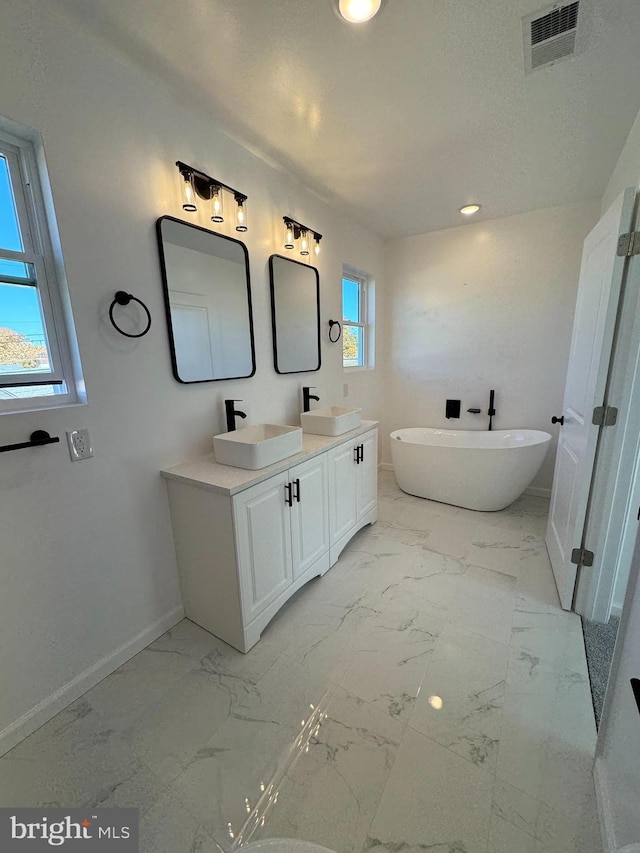 bathroom featuring vanity and a bathtub