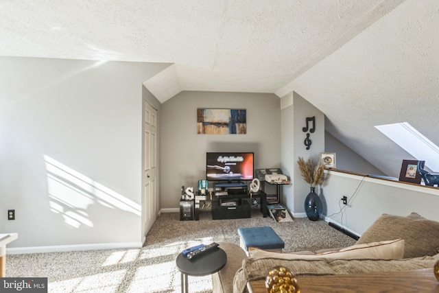 carpeted living room with lofted ceiling with skylight and a textured ceiling