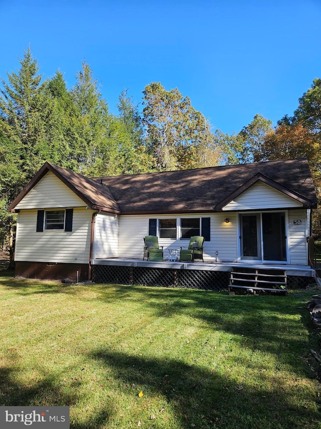 exterior space featuring a wooden deck and a lawn