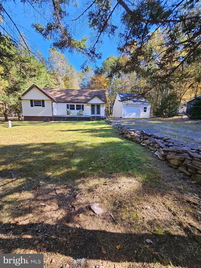 view of front facade with an outdoor structure, a front yard, and a garage