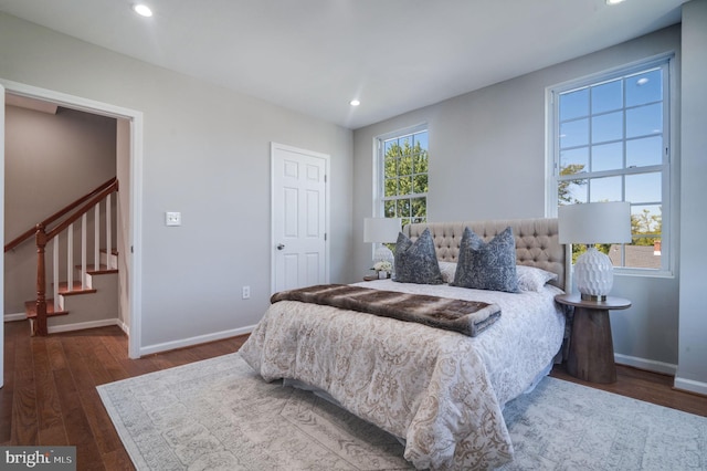 bedroom with dark hardwood / wood-style floors