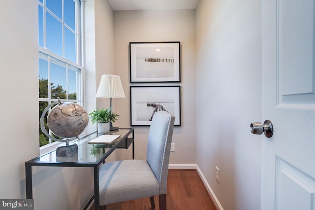 office area featuring a wealth of natural light and dark wood-type flooring