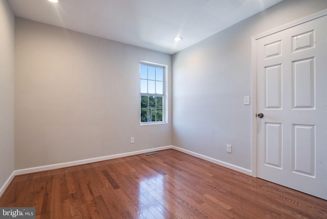 spare room featuring hardwood / wood-style flooring