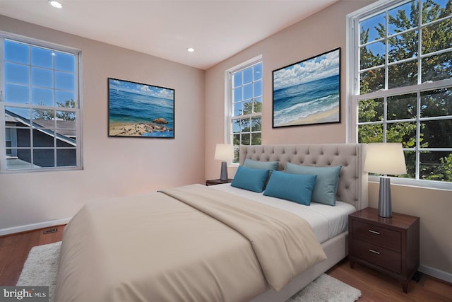 bedroom featuring hardwood / wood-style floors and multiple windows