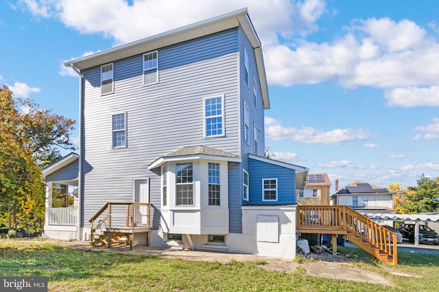 rear view of property with a lawn