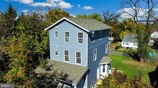 view of side of property with a yard