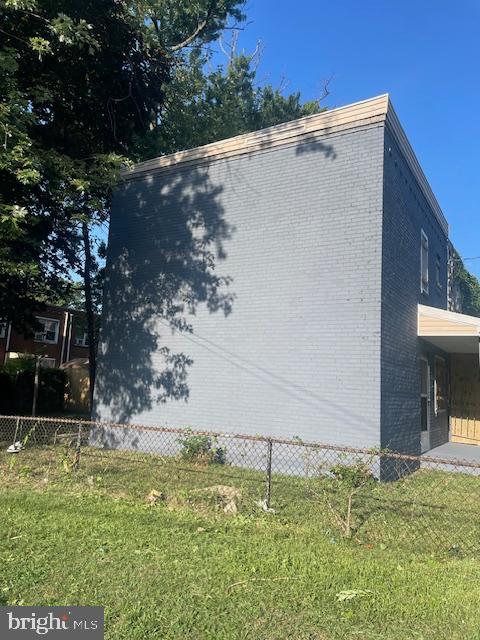 view of side of home featuring a lawn