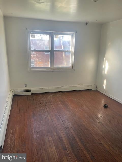 unfurnished room with a baseboard heating unit, dark hardwood / wood-style floors, and plenty of natural light